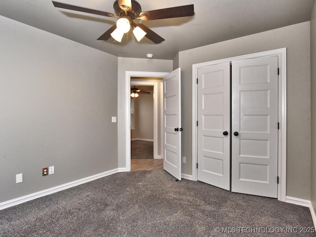 unfurnished bedroom with a closet, ceiling fan, and dark colored carpet