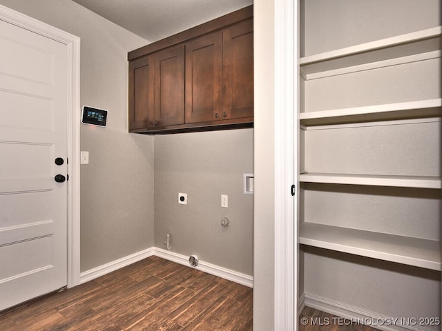 laundry room with gas dryer hookup, cabinets, hookup for an electric dryer, and dark hardwood / wood-style flooring