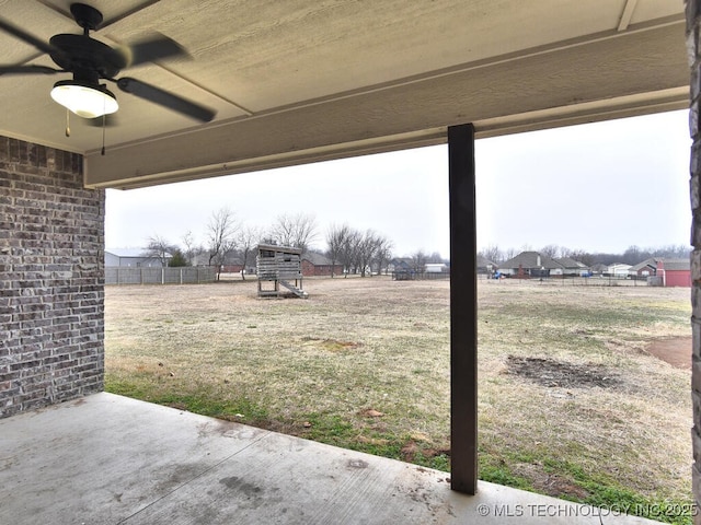 view of yard featuring ceiling fan, a playground, and a patio