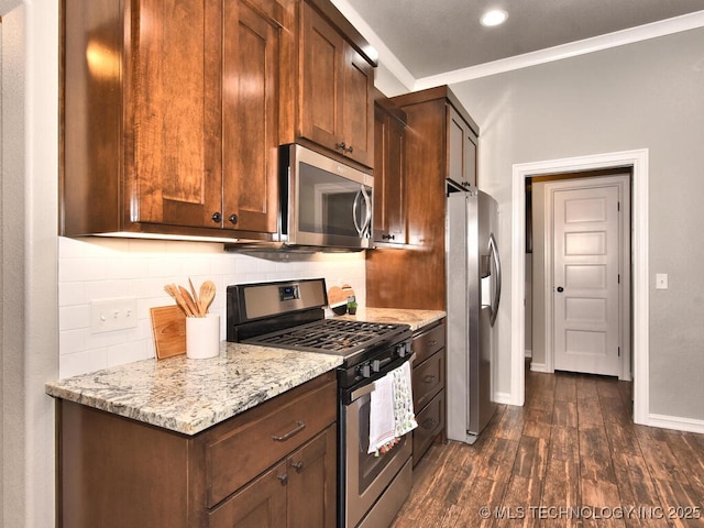 kitchen with crown molding, stainless steel appliances, dark hardwood / wood-style floors, tasteful backsplash, and light stone countertops