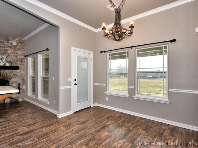 unfurnished dining area with an inviting chandelier, crown molding, and dark hardwood / wood-style floors