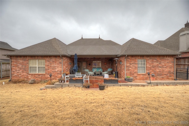 back of house with a yard and a patio area