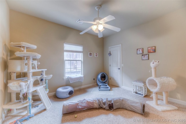 interior space with ceiling fan and carpet