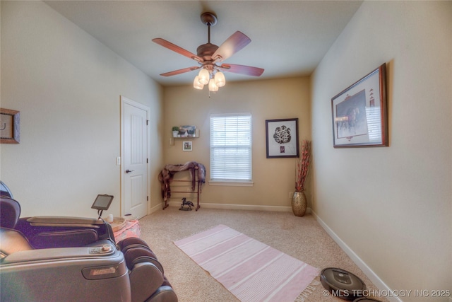 sitting room featuring light carpet and ceiling fan