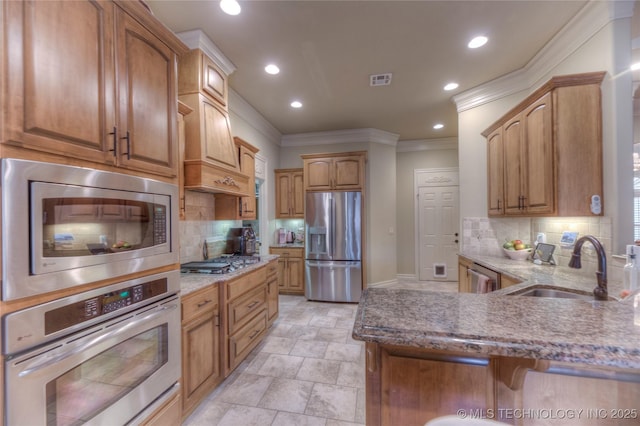 kitchen with stainless steel appliances, crown molding, sink, and tasteful backsplash