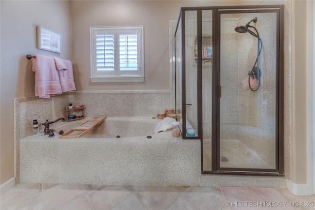 bathroom with tile patterned floors and shower with separate bathtub