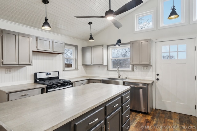 kitchen with stainless steel appliances, sink, pendant lighting, and gray cabinetry