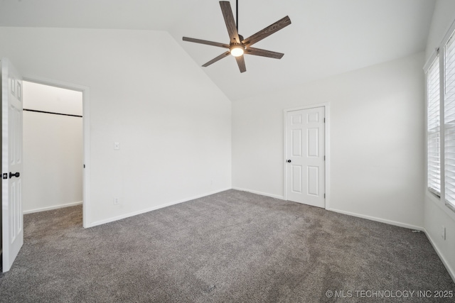 carpeted empty room with high vaulted ceiling and ceiling fan