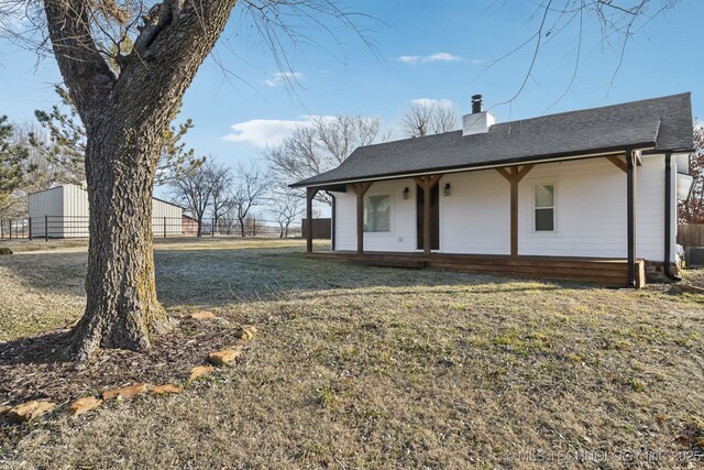 rear view of property with a lawn