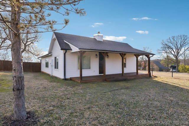 exterior space featuring a porch and a lawn