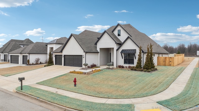 view of front of property featuring a garage and a front lawn