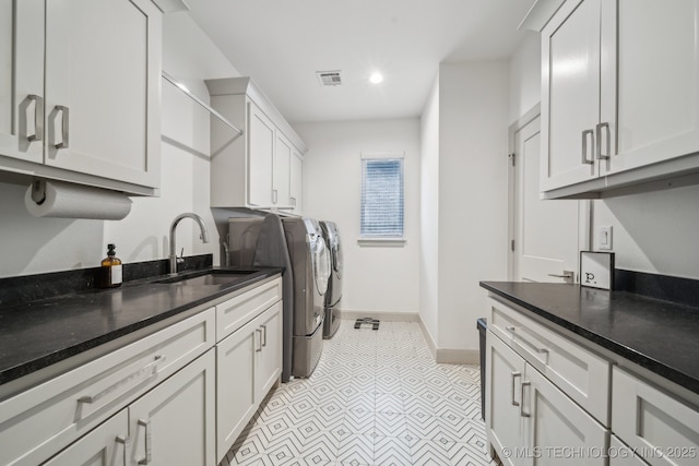 laundry area with cabinets, sink, and washer and dryer