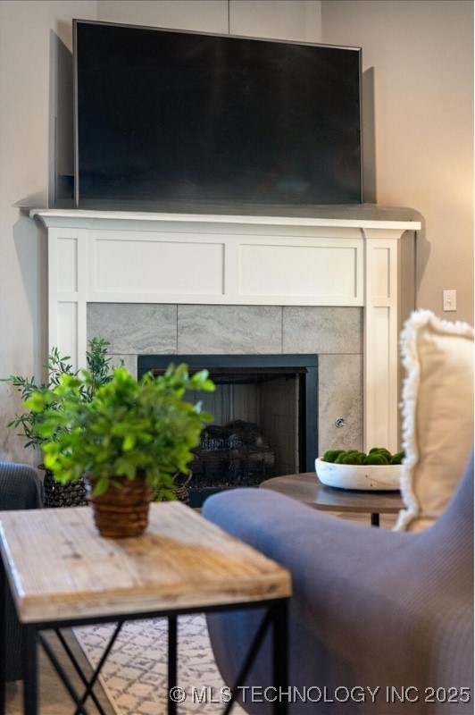 interior details featuring a tile fireplace