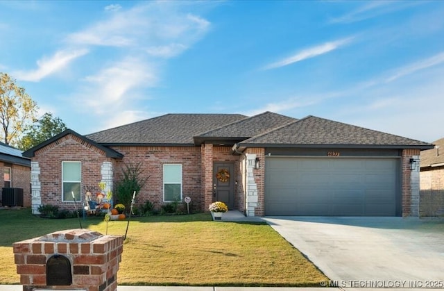 view of front of house with a garage, a front lawn, and central air condition unit