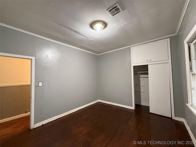 unfurnished bedroom featuring dark hardwood / wood-style floors and a closet