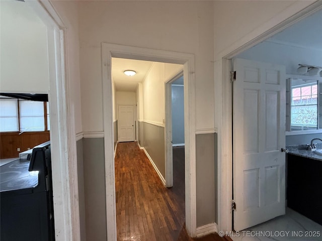 corridor featuring dark hardwood / wood-style flooring