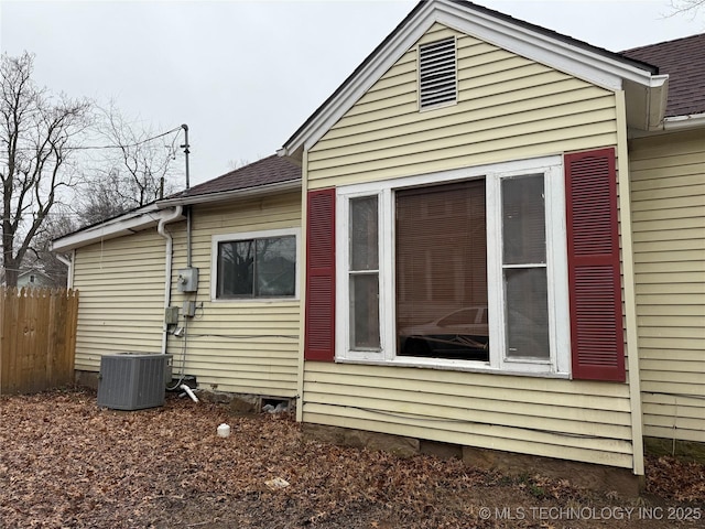 view of side of home with central AC unit