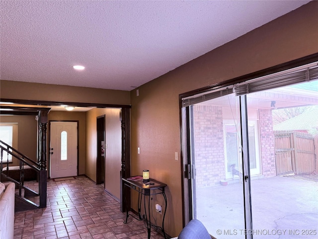 entryway with a textured ceiling