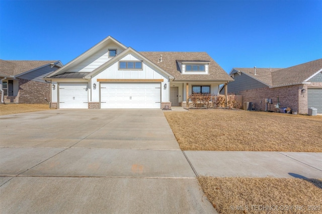 craftsman-style house featuring a garage and central AC unit