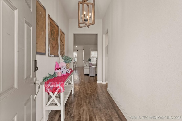 hall featuring dark hardwood / wood-style flooring and a notable chandelier