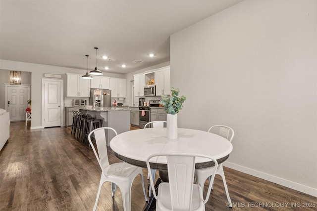 dining area with dark wood-type flooring