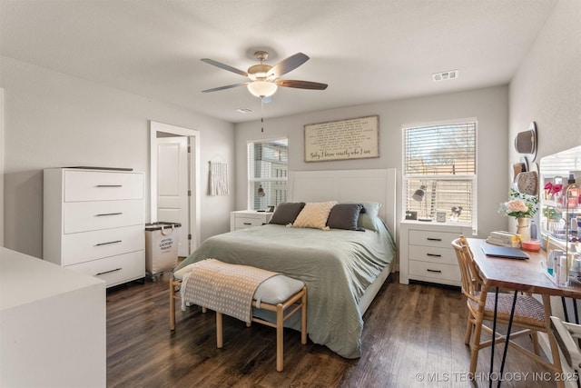 bedroom with dark hardwood / wood-style flooring and ceiling fan