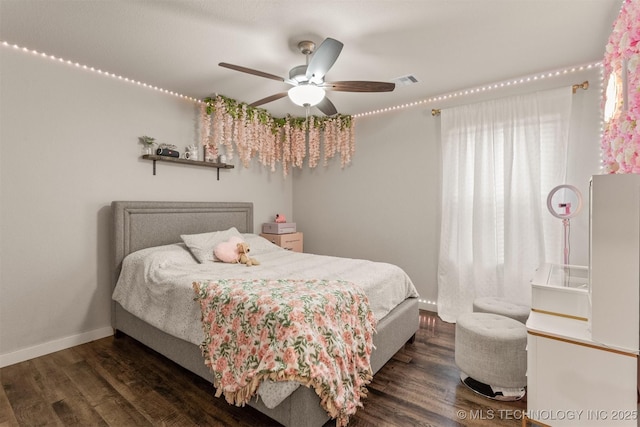 bedroom with ceiling fan and dark hardwood / wood-style floors