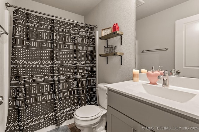 bathroom featuring vanity, a shower with shower curtain, and toilet