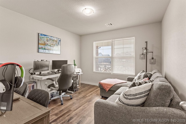 office space with wood-type flooring and a textured ceiling