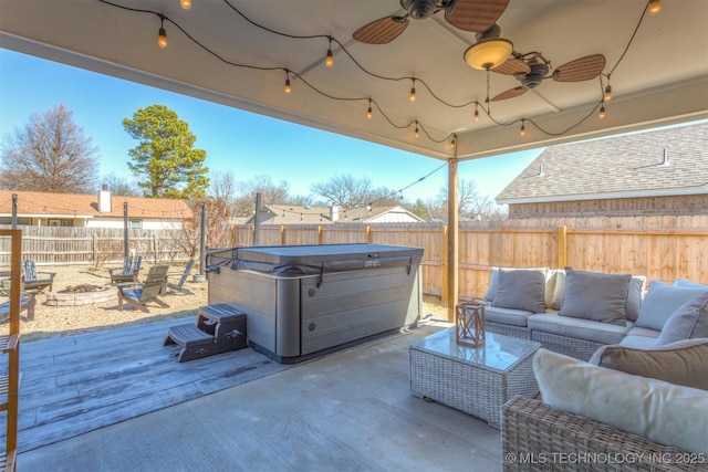 view of patio featuring a wooden deck, an outdoor living space with a fire pit, a hot tub, and ceiling fan