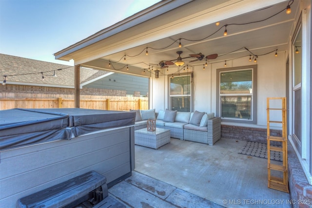 view of patio / terrace with ceiling fan and a hot tub