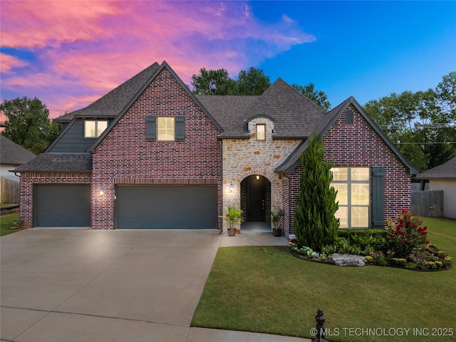 view of front of home featuring a yard and a garage