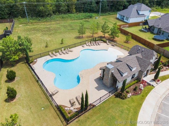 view of pool with a lawn