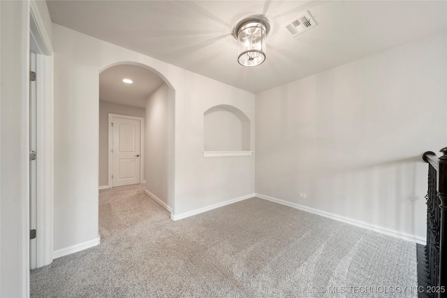 unfurnished room featuring light colored carpet