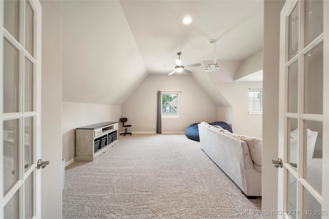 interior space with french doors, lofted ceiling, and light carpet