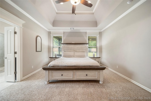 unfurnished bedroom featuring light colored carpet, ornamental molding, a raised ceiling, and multiple windows