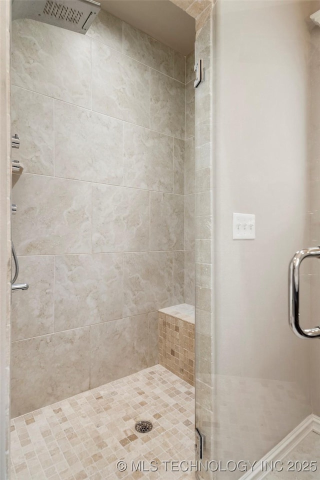 bathroom featuring a shower with door