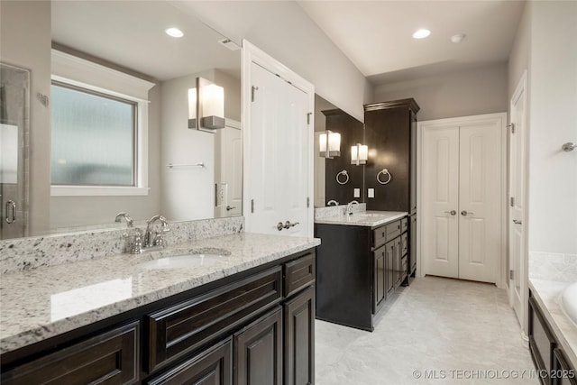 bathroom with tile patterned floors, vanity, and a bathing tub