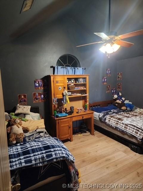 bedroom with lofted ceiling and hardwood / wood-style flooring