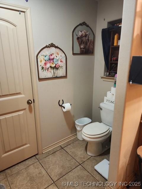 bathroom featuring toilet and tile patterned flooring