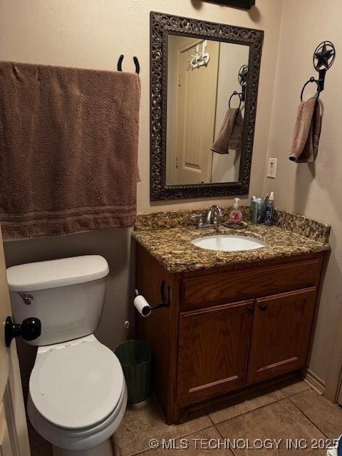 bathroom with vanity, tile patterned floors, and toilet