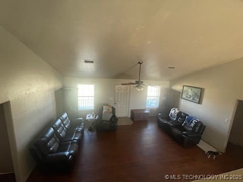 living room featuring ceiling fan and dark hardwood / wood-style flooring