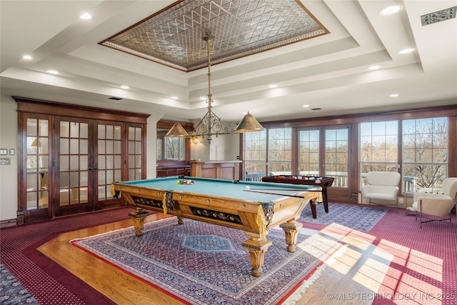 recreation room featuring a tray ceiling, billiards, french doors, and hardwood / wood-style flooring