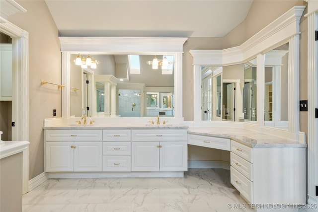 bathroom with vanity, a chandelier, and a shower with door