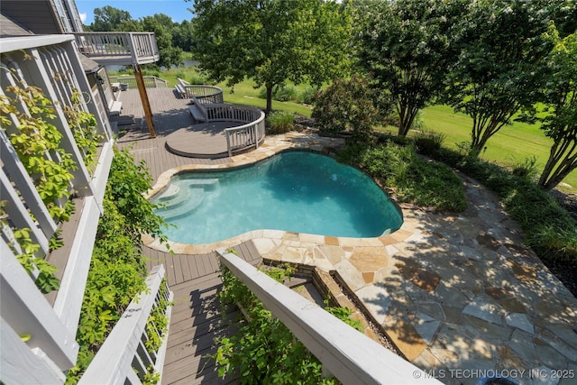 view of pool with a wooden deck and a patio area