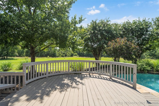 wooden terrace featuring a lawn