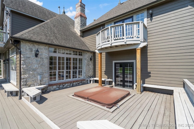 wooden deck with a covered hot tub