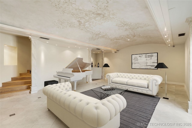 tiled living room featuring lofted ceiling and ornate columns