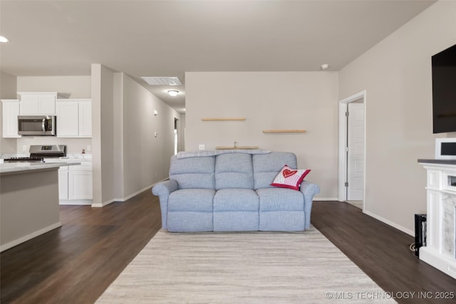 living room featuring baseboards, visible vents, and dark wood-type flooring