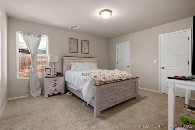 bedroom with visible vents, light carpet, and baseboards